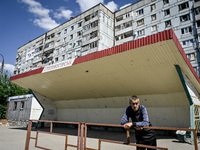 A local is staying at a stop in the rural settlement of Stepnohirsk, Ukraine, on June 28, 2024, which is shelled daily by Russian troops as...