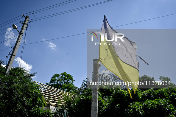 A flag of Ukraine is flying in the street in the rural settlement of Stepnohirsk, Ukraine, on June 28, 2024, which is being shelled daily by...