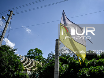 A flag of Ukraine is flying in the street in the rural settlement of Stepnohirsk, Ukraine, on June 28, 2024, which is being shelled daily by...