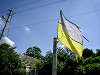 A flag of Ukraine is flying in the street in the rural settlement of Stepnohirsk, Ukraine, on June 28, 2024, which is being shelled daily by...