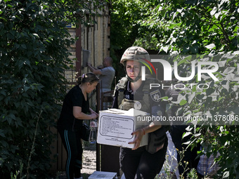 A police officer is helping local Iryna during the evacuation from the rural settlement of Stepnohirsk that is being shelled daily by Russia...