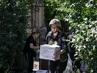 A police officer is helping local Iryna during the evacuation from the rural settlement of Stepnohirsk that is being shelled daily by Russia...