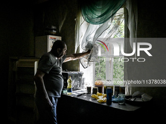 Volodymyr is looking out of the window during the evacuation from the rural settlement of Stepnohirsk, which is being shelled daily by Russi...