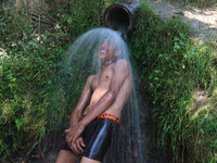 A Kashmiri boy is cooling off under an overflowing water pipe during a hot day on the outskirts of Srinagar, Jammu And Kashmir, on July 2, 2...