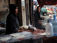 A displaced Palestinian woman is frying falafel at a stall in Deir el-Balah in the central Gaza Strip on July 2, 2024, amid the ongoing conf...