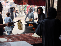 A displaced Palestinian woman is frying falafel at a stall in Deir el-Balah in the central Gaza Strip on July 2, 2024, amid the ongoing conf...