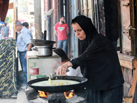 A displaced Palestinian woman is frying falafel at a stall in Deir el-Balah in the central Gaza Strip on July 2, 2024, amid the ongoing conf...