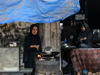 A displaced Palestinian woman is frying falafel at a stall in Deir el-Balah in the central Gaza Strip on July 2, 2024, amid the ongoing conf...