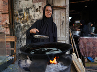 A displaced Palestinian woman is frying falafel at a stall in Deir el-Balah in the central Gaza Strip on July 2, 2024, amid the ongoing conf...