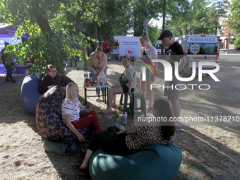 Residents are staying outside the apartment block hit by a Russian missile on June 28 during a response effort in Dnipro, Ukraine, on June 3...