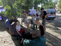 Residents are staying outside the apartment block hit by a Russian missile on June 28 during a response effort in Dnipro, Ukraine, on June 3...