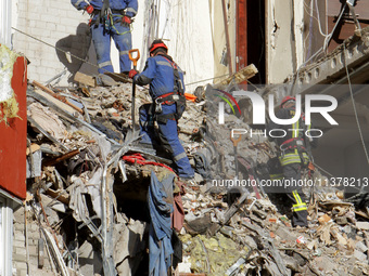 Rescuers are removing the rubble at the apartment block hit by a Russian missile in Dnipro, Ukraine, on June 30, 2024. NO USE RUSSIA. NO USE...