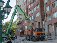 A crane and container are being used to remove the rubble at the apartment block hit by a Russian missile in Dnipro, Ukraine, on June 30, 20...