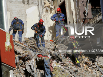 Rescuers are removing the rubble at the apartment block hit by a Russian missile in Dnipro, Ukraine, on June 30, 2024. NO USE RUSSIA. NO USE...