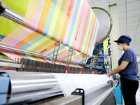 Workers are producing towel products for export at a workshop of a towel manufacturer in Binzhou, China, on July 2, 2024. (