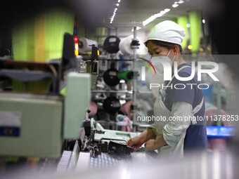 Workers are producing towel products for export at a workshop of a towel manufacturer in Binzhou, China, on July 2, 2024. (