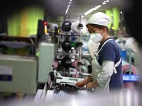 Workers are producing towel products for export at a workshop of a towel manufacturer in Binzhou, China, on July 2, 2024. (