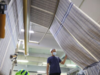 Workers are producing towel products for export at a workshop of a towel manufacturer in Binzhou, China, on July 2, 2024. (