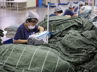 Workers are producing towel products for export at a workshop of a towel manufacturer in Binzhou, China, on July 2, 2024. (