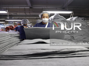 Workers are producing towel products for export at a workshop of a towel manufacturer in Binzhou, China, on July 2, 2024. (