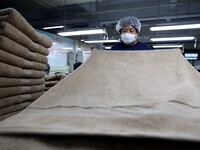 Workers are producing towel products for export at a workshop of a towel manufacturer in Binzhou, China, on July 2, 2024. (