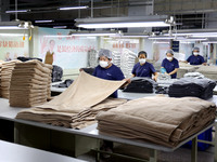 Workers are producing towel products for export at a workshop of a towel manufacturer in Binzhou, China, on July 2, 2024. (