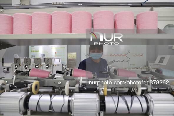 Workers are producing towel products for export at a workshop of a towel manufacturer in Binzhou, China, on July 2, 2024. 