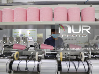 Workers are producing towel products for export at a workshop of a towel manufacturer in Binzhou, China, on July 2, 2024. (