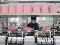 Workers are producing towel products for export at a workshop of a towel manufacturer in Binzhou, China, on July 2, 2024. (