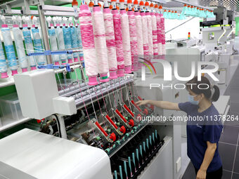 Workers are producing towel products for export at a workshop of a towel manufacturer in Binzhou, China, on July 2, 2024. (