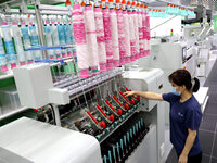 Workers are producing towel products for export at a workshop of a towel manufacturer in Binzhou, China, on July 2, 2024. (