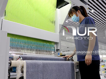 Workers are producing towel products for export at a workshop of a towel manufacturer in Binzhou, China, on July 2, 2024. (