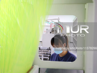 Workers are producing towel products for export at a workshop of a towel manufacturer in Binzhou, China, on July 2, 2024. (