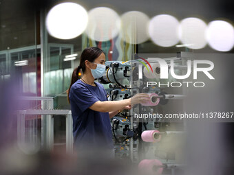 Workers are producing towel products for export at a workshop of a towel manufacturer in Binzhou, China, on July 2, 2024. (