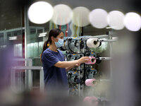 Workers are producing towel products for export at a workshop of a towel manufacturer in Binzhou, China, on July 2, 2024. (