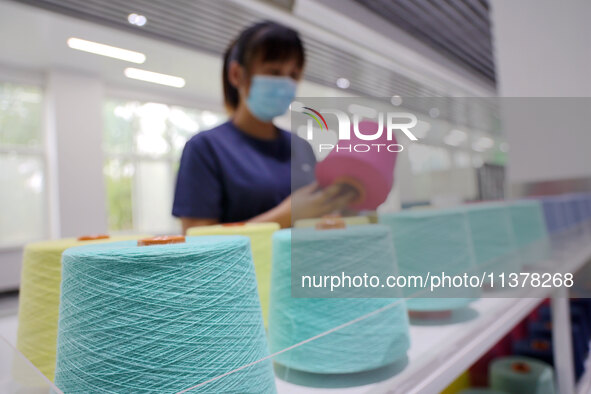 Workers are producing towel products for export at a workshop of a towel manufacturer in Binzhou, China, on July 2, 2024. 