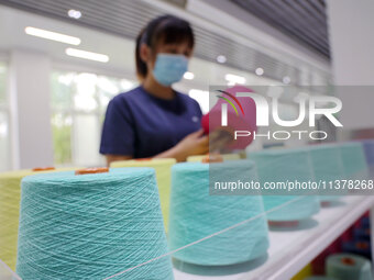 Workers are producing towel products for export at a workshop of a towel manufacturer in Binzhou, China, on July 2, 2024. (