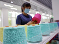 Workers are producing towel products for export at a workshop of a towel manufacturer in Binzhou, China, on July 2, 2024. (