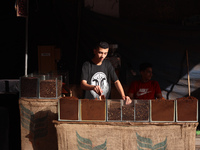 A coffee merchant is manning his stall by whole and ground coffee beans at a shop in Deir el-Balah in the central Gaza Strip on July 2, 2024...