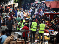 People are walking along a crowded market street in Deir el-Balah in the central Gaza Strip on July 2, 2024, amid the ongoing conflict in th...