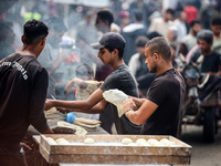 People are walking along a crowded market street in Deir el-Balah in the central Gaza Strip on July 2, 2024, amid the ongoing conflict in th...