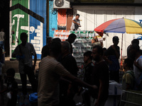 People are walking along a crowded market street in Deir el-Balah in the central Gaza Strip on July 2, 2024, amid the ongoing conflict in th...