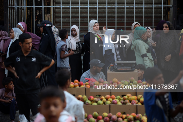 Displaced Palestinian women are queuing for bread in Deir el-Balah in the central Gaza Strip on July 2, 2024, amid the ongoing conflict in t...