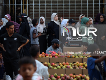 Displaced Palestinian women are queuing for bread in Deir el-Balah in the central Gaza Strip on July 2, 2024, amid the ongoing conflict in t...