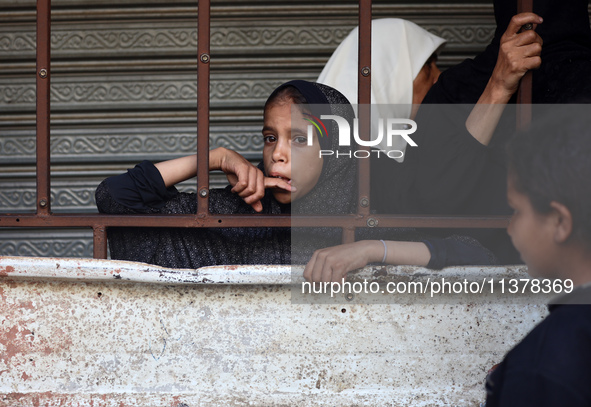 Displaced Palestinian women are queuing for bread in Deir el-Balah in the central Gaza Strip on July 2, 2024, amid the ongoing conflict in t...