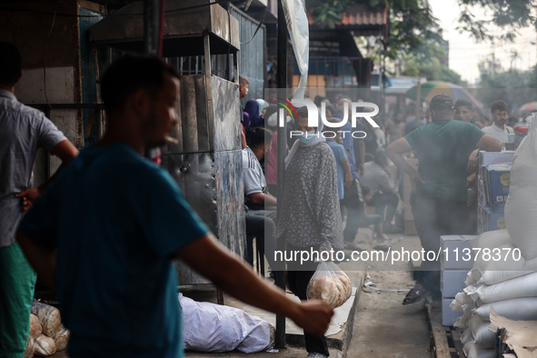 Displaced Palestinian women are queuing for bread in Deir el-Balah in the central Gaza Strip on July 2, 2024, amid the ongoing conflict in t...