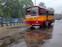 A minibus is running on the street in rainy weather in Kolkata, India, on July 2, 2024. (