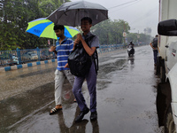 People are walking on the street in rainy weather in Kolkata, India, on July 2, 2024. (