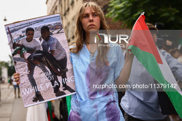 A woman attends solidarity with Palestine demonstration at Kazimierz, the Jewish historic district in Krakow, Poland on June 30, 2024.  A pr...