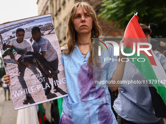 A woman attends solidarity with Palestine demonstration at Kazimierz, the Jewish historic district in Krakow, Poland on June 30, 2024.  A pr...